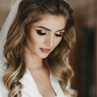 woman looking down in wedding gown showing eye makeup