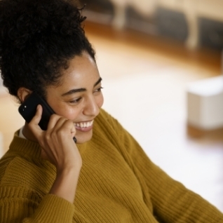 woman holding cell phone talking on phone