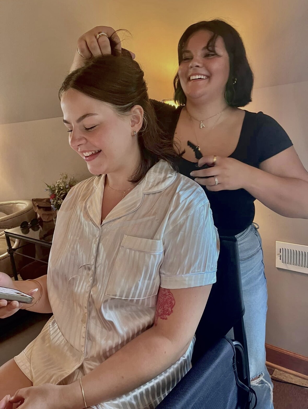 woman sitting while having hair done